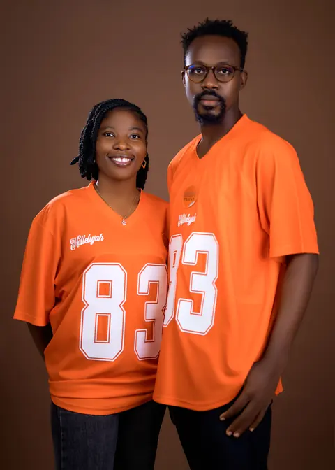 Two models in the orange colourway