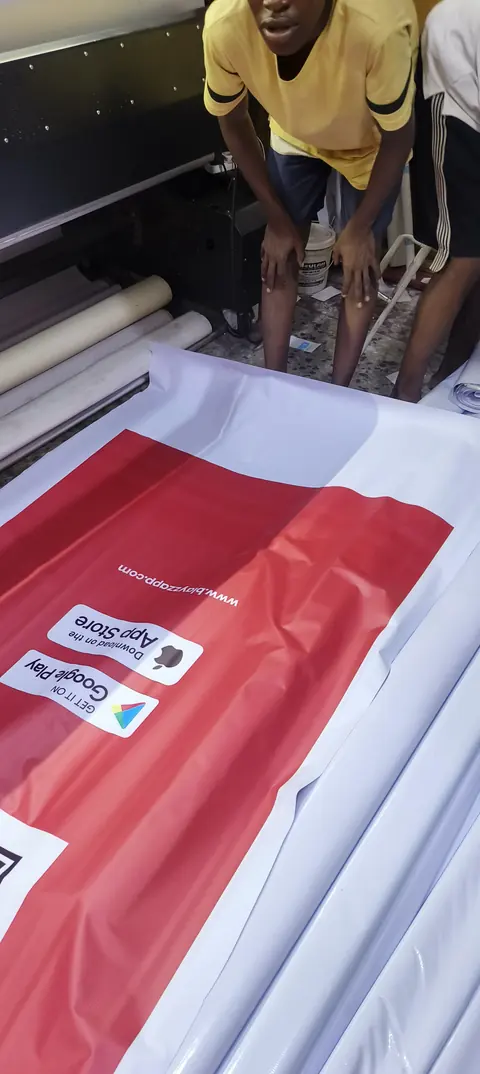 The team laying out a printed banner for finishing