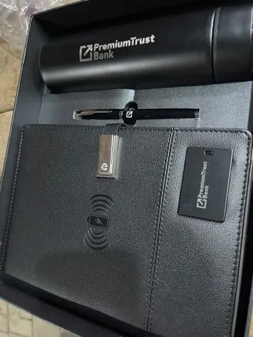 A branded folder and pen produced for PremiumTrust Bank