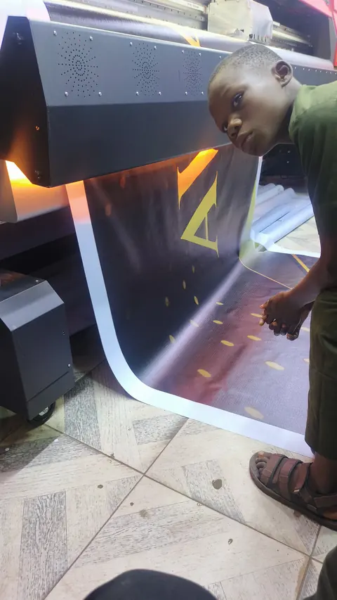 An operator guiding a sheet off the press