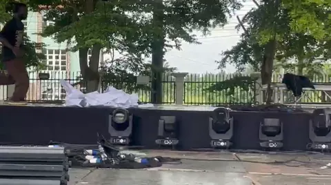 Moving-head fixtures staged before rigging