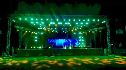 A stage lit green at night